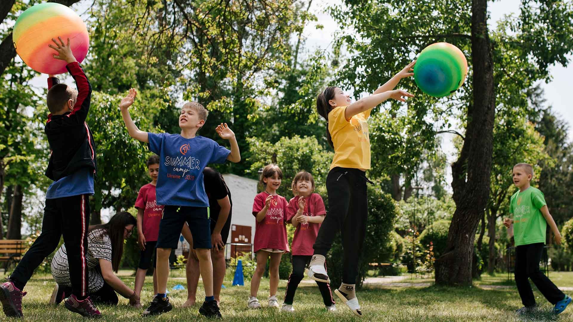 Children playing catch at a summer camp, Ukraine.