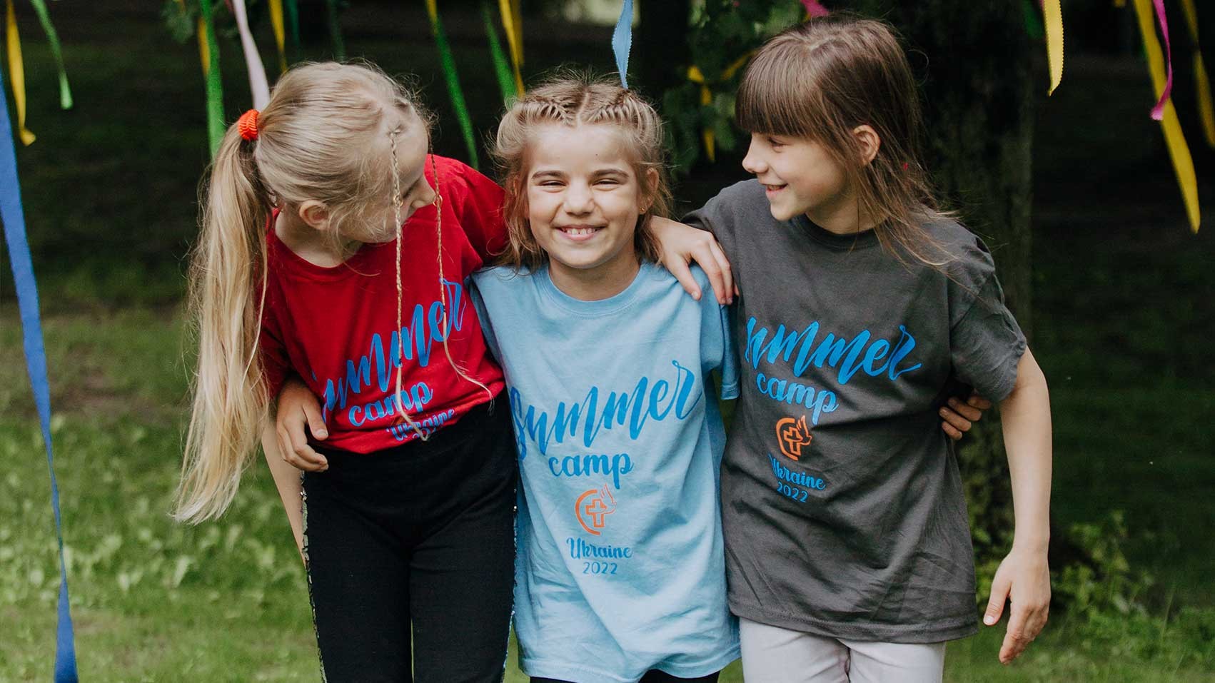Three girls enjoy Summer Camp in Ukraine.