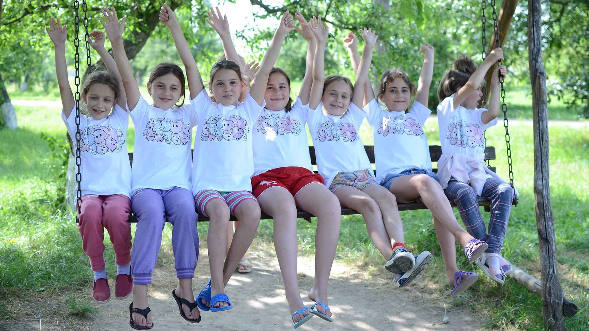 Children enjoy a swing at summer camp.