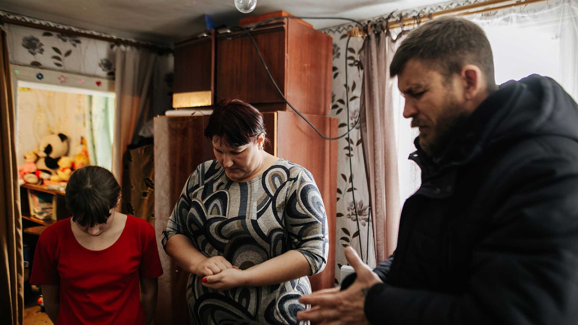 A family praying in Ukraine.