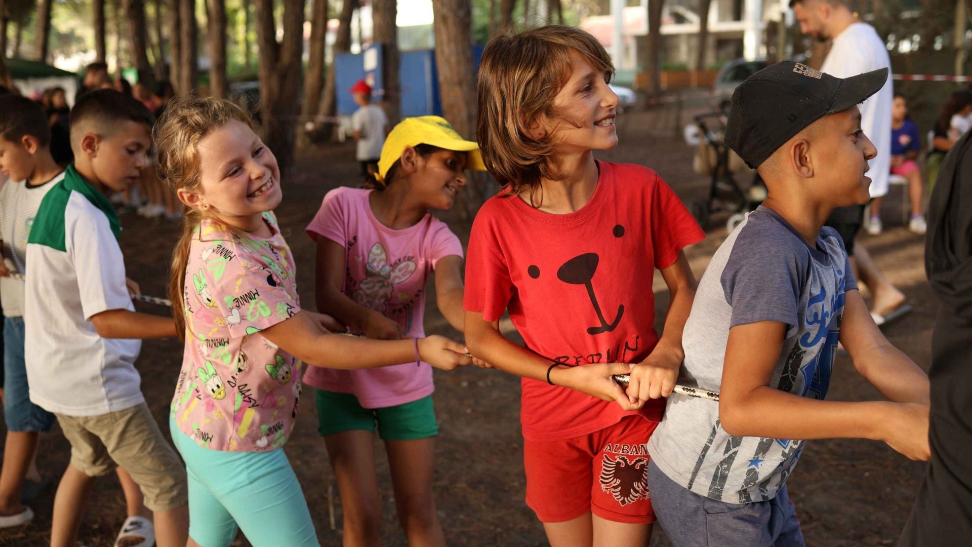 Children play tug of war at summer camp.