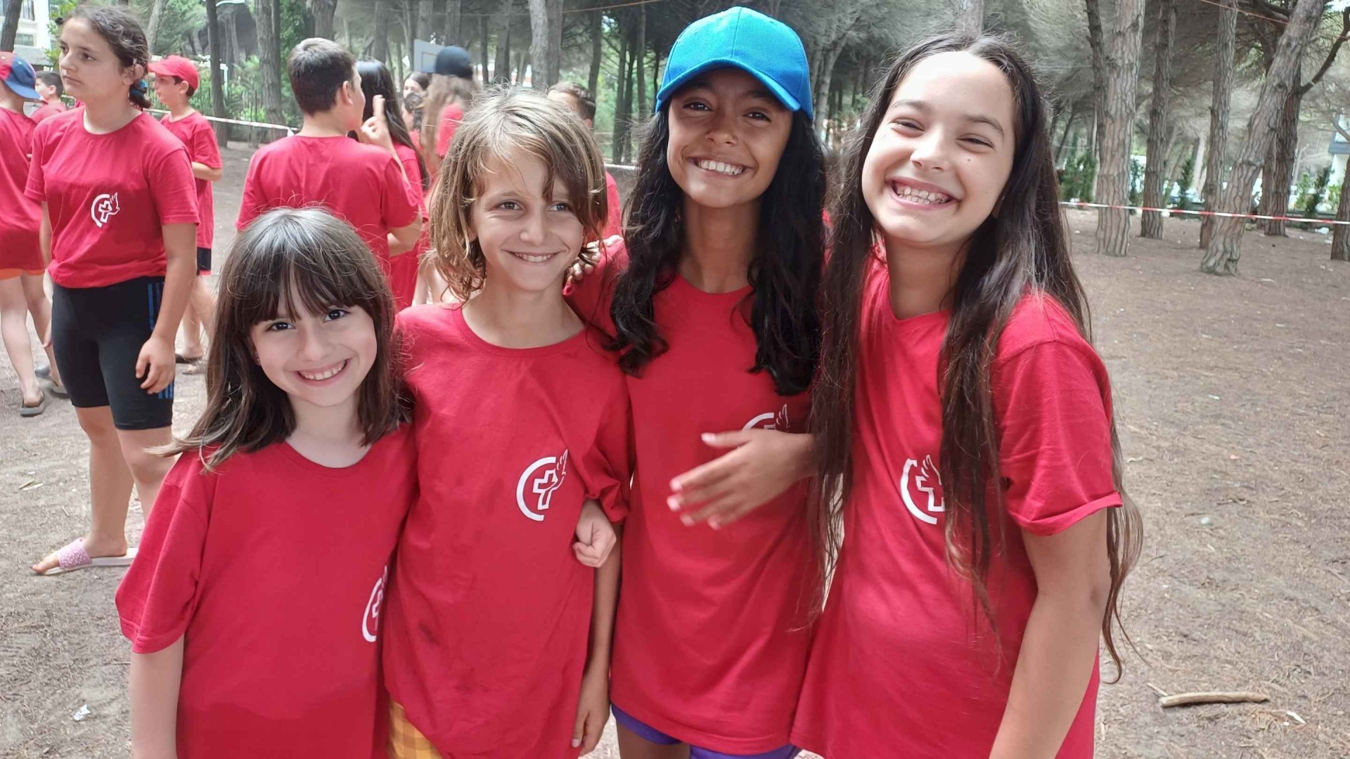 A group of smiling children at a summer camp.
